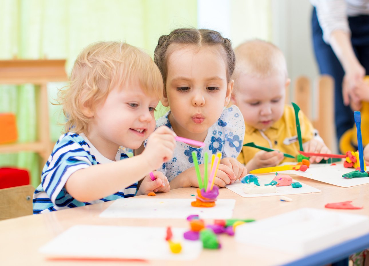 happy kids doing arts and crafts in day care centre