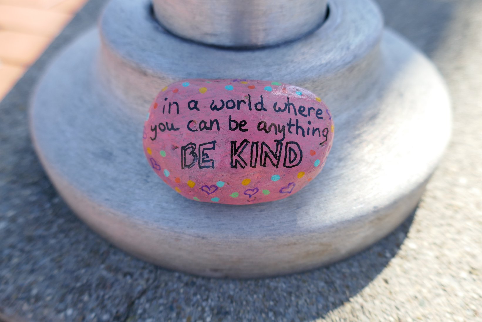 Be kind message painted onto pink kindness rock